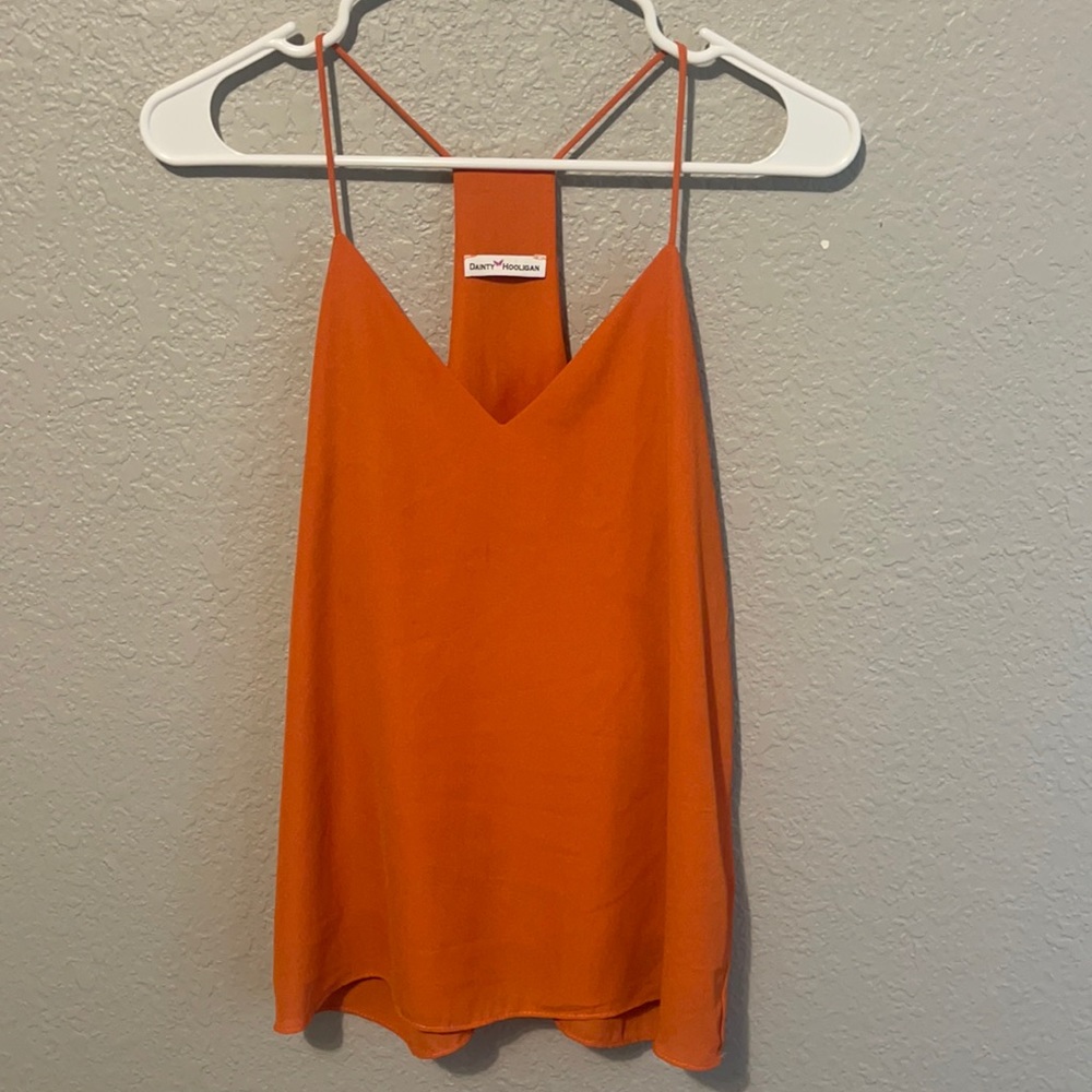 This is a dainty hooligan top, orange and medium sized.